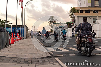 Woman with a scooter in Male, Maldives Editorial Stock Photo