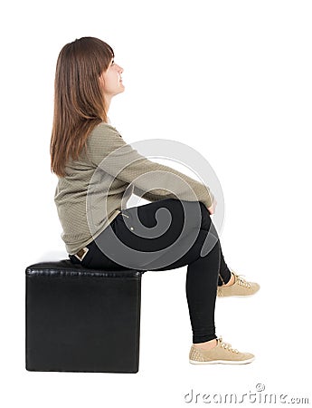 Back view of young beautiful woman sitting. Stock Photo