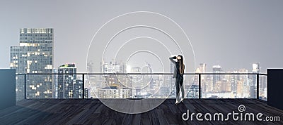 Back view of young businesswoman looking into the distance on rooftop with night sky and wide city view. Success, future and Stock Photo