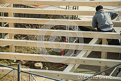 Back view of young carpenter building a carport Stock Photo