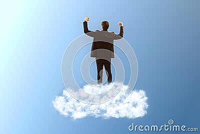 Back view of young caucasian businessman standing on cloud. Blue sky background. Dream big, business and strategy, forethought and Stock Photo