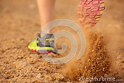 Back of woman shoe running on dirt road Stock Photo