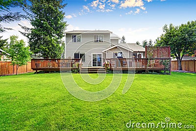 Back yard house exterior with spacious wooden deck Stock Photo