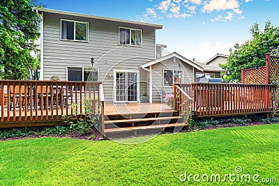 Back yard house exterior with spacious wooden deck Stock Photo