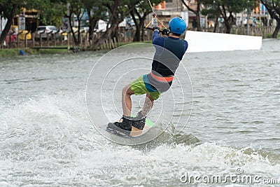 back of the young man wake boarding on a lake with cable in Bangkok Thailand. Concept sport and leisure activities Editorial Stock Photo