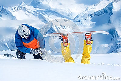 Backcountry snowboarder digging out his friend Stock Photo