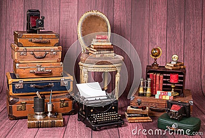 Backdrop with vintage decor and accesories like suitcases, books, typewriter, chair Stock Photo