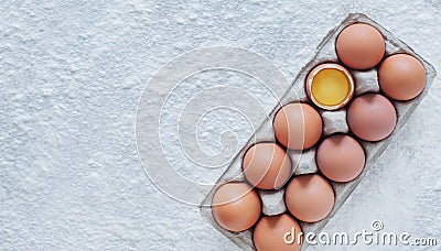 Background for baking. Eggs and sprinkled flour on the table. view from above. copy space Stock Photo