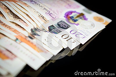 Money of United Kingdom close up on black background. Pounds UK 10 and 20 note Editorial Stock Photo