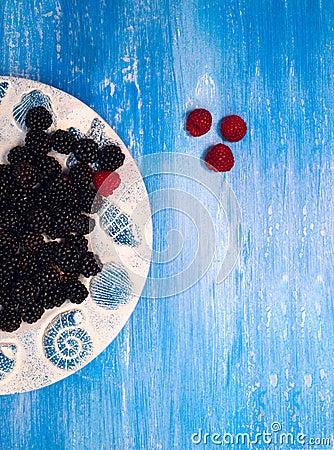 Background - Berries, Blackberry, blueberries on blue Stock Photo