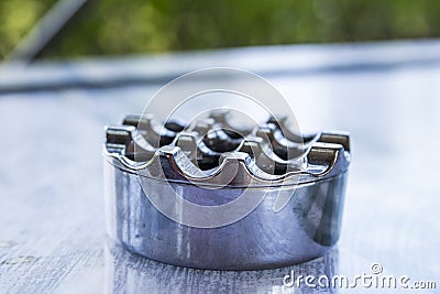 Background blur metal ashtray on the surface of the table Stock Photo