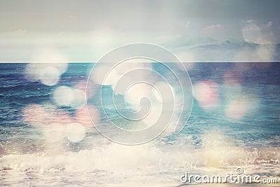 Background of blurred beach and sea waves with bokeh lights Stock Photo