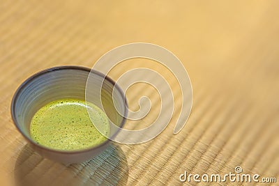 Ceramic Chawan Cup of Japanese Matcha green tea on a tatami mat. Stock Photo