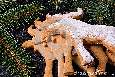 Background with Christmas cookies gingerbread. On the right side of the frame cake in the shape of a moose. Stock Photo