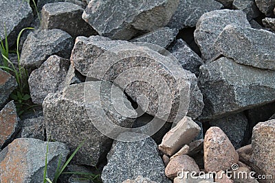 A background of cobblestone stones close-up. stones for the construction of the foundation. Crisis construction of expensive Stock Photo