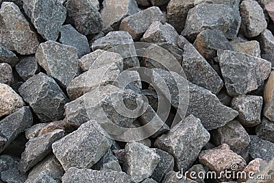 A background of cobblestone stones close-up. stones for the construction of the foundation. Crisis construction of expensive Stock Photo