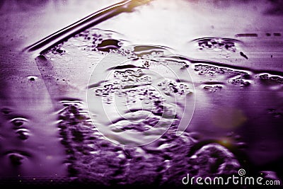 background, colored glass wet drops and strip of water create plays of color Stock Photo