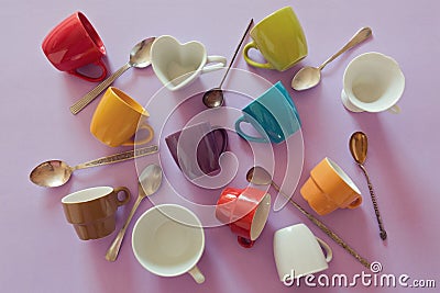 Background with colorful empty coffee cups and spoons. View from above Stock Photo