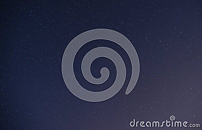Background of dark-blue night sky with countless twinkle stars and moving white clouds upon on it Stock Photo