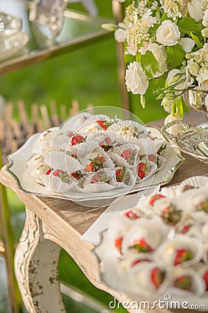 Background from desserts prepared for guests of a Wedding party or birthday Strawberry in white Milk Chocolate next to Stock Photo