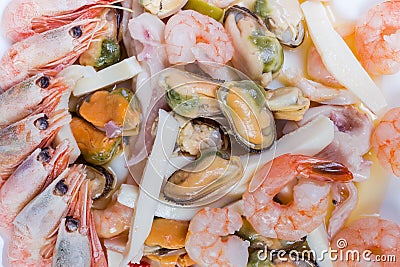 Background of different cooked seafoods on dish, fragment close-up Stock Photo