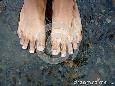 background of feet soaking in river water Stock Photo