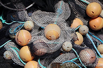 Background of Fishing Net Pile with Yellow Floats Stock Photo