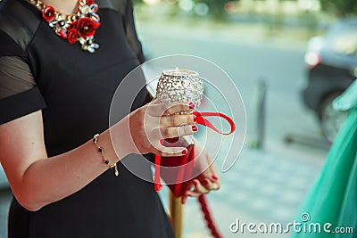 The girl decorated with a decorative candlestick in her hands and a sign . holds a candle in her hand . in the background without Stock Photo