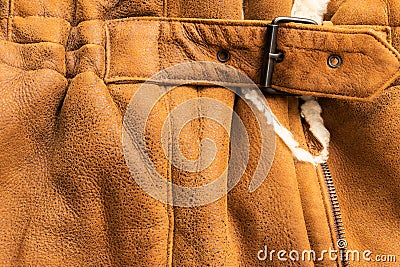 Background in the form of a fragment of the back of a winter jacket made of genuine brown soft leather Stock Photo