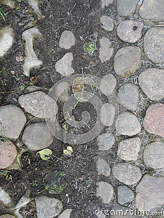 Background. fragment. texture. the old road is paved with wild stone, cobblestones. landscape design, natural style. Stock Photo