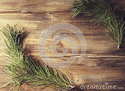 Background frame with pine tree branch on old wooden background board Stock Photo