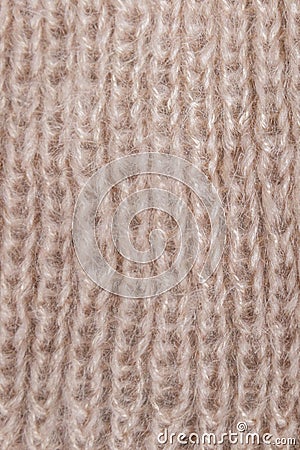Background from gently pink woolen knitted threads. Hobby manual labor. Space for text. Close-up. Vertical Stock Photo