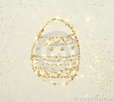 Background with glittering Easter egg on paper in nostalgic colors, made with golden glitter Stock Photo