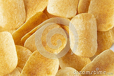 Background golden potato chips texture. Crispy unhealthy snack isolated Stock Photo