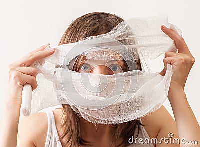 The girl covered her face with bandage on white background Stock Photo