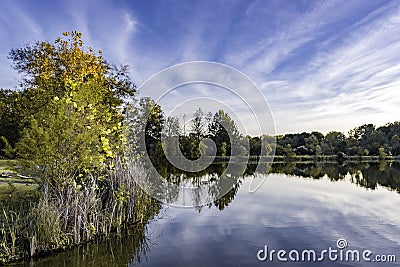 Background image of a lake with fall folliage and blue sky with Stock Photo