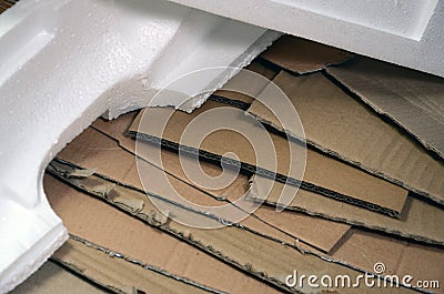 Background image with a lot of beige cardboard paper and styrofoam boxes disgarded as rubbish. The concept of unpacking new home Stock Photo