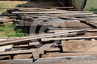 Background image, lots of wood planks demolished from old houses, piles of scraps, outdoor space, selectable focus. Stock Photo