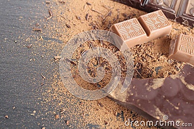 Background International Chocolate Day milky dark chocolate on a grey black background with a copyspace place for text Stock Photo