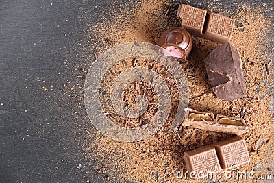 Background International Chocolate Day milky dark chocolate on a grey black background with a copyspace place for text Stock Photo