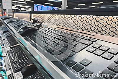 Background, keyboard and mouse on the shelves in the technology store. Choosing and buying a keyboard in a technology store Stock Photo