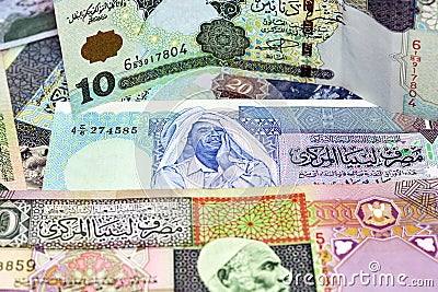 Background of Libyan money dinars banknotes with portraits of Omar Al-Mukhtar and Muammar Gaddafi on some banknotes Stock Photo