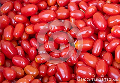 Background of lots of organic red grape tomatoes Stock Photo