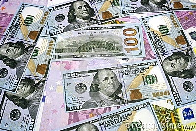 The background of the many currencies the Euro EUR with 500, 200, 100 dollars and euros banknotes. A lot of money. The Euro Stock Photo