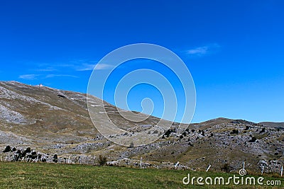In the background, mountain desolation, with little vegetation. On the way to the mountain Bjelasnica Stock Photo