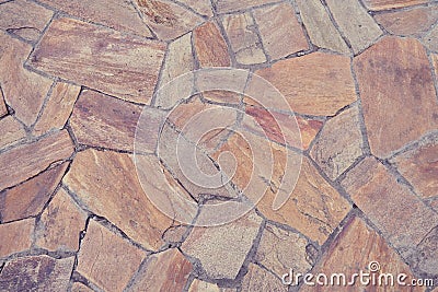 Background of old brown tiles made of irregular shaped stones Stock Photo