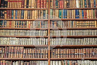 Background of old vintage books on wood bookshelf in a library Editorial Stock Photo