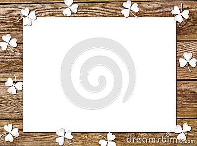 Background paper clover leaves on the old wooden boards. St.Patrick`s day holiday symbol Stock Photo