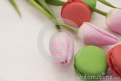 Background with pink tulips and macaroons. Stock Photo