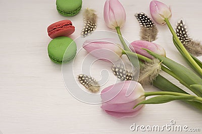 Background with pink tulips and macaroons. Stock Photo